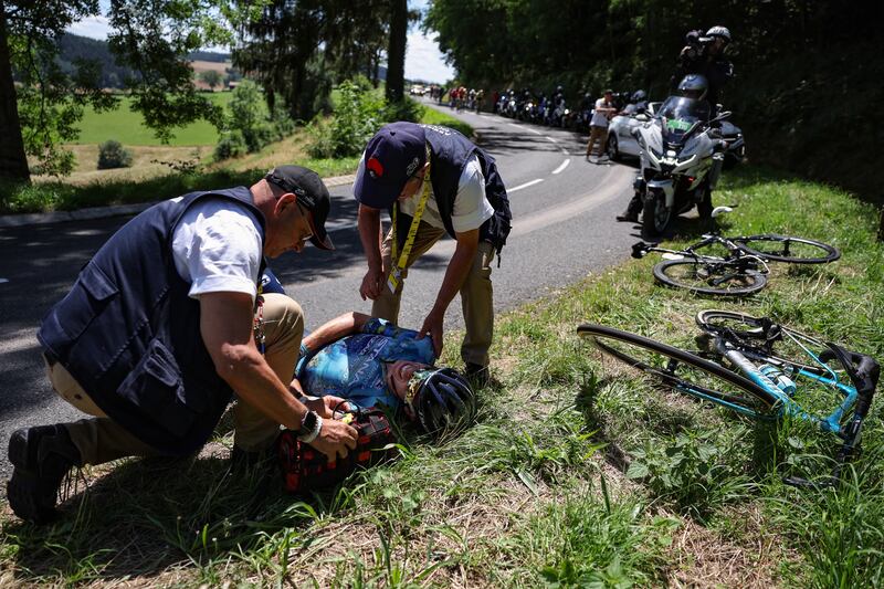 Astana Qazaqstan Team's Spanish rider David De La Cruz receives medical attention after crashing during the 12th stage of Tour de France. Photograph: Thomas Samson / AFP via Getty Images.