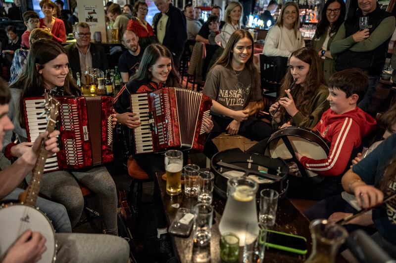A traditional music session in the Fleet Inn, KIllybegs. Photograph: Finbarr O'Reilly/New York Times
                      