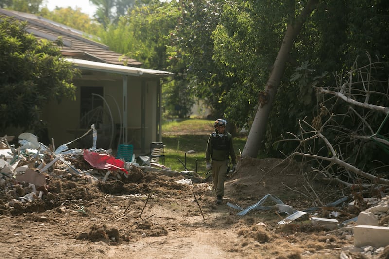 A member of the Israeli army's rescue crew searches for bodies after the Hamas-led attack on southern Israel on October 7th, 2023. Photograph: Amir Levy/Getty Images