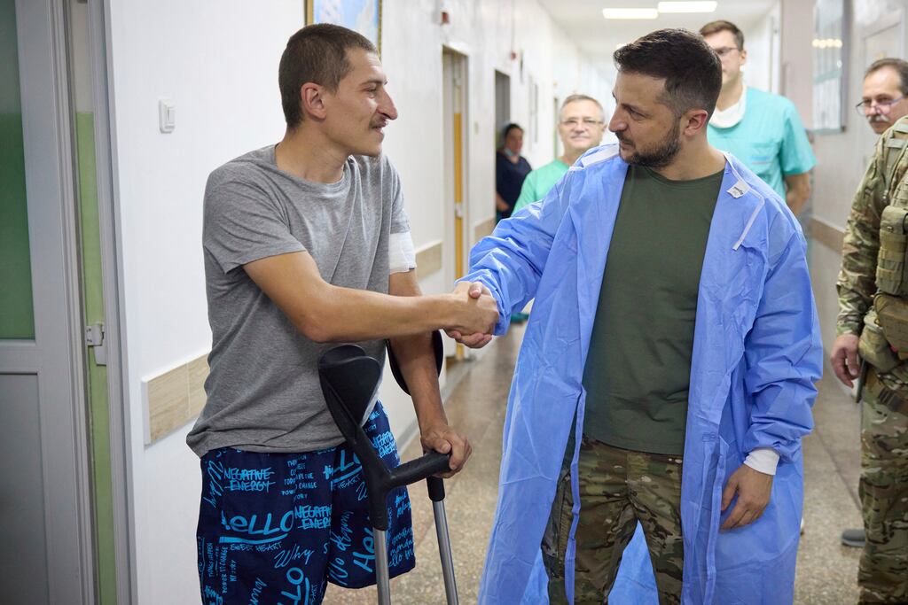 Ukrainian president Volodymyr Zelenskiy shakes hands with a wounded soldier in a city hospital in Odesa. Photograph: AP