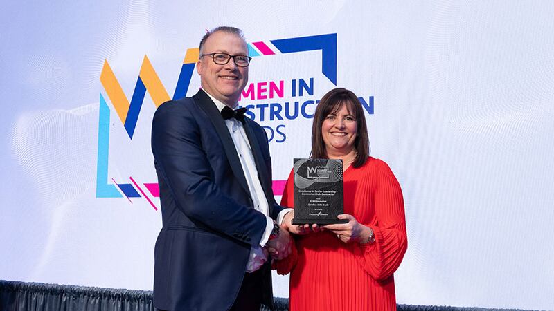 Tomás Kelly, awards judge, presents the excellence in senior leadership - contractor/sub-contractor award to Caroline Ashe Brady, KORE Insulation