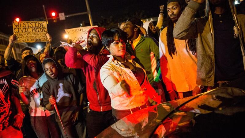 People protesting the death of Freddie Gray and demanding police accountability move into the streets in the Sandtown neighborhood where Gray was arrested. Photograph:  Andrew Burton/Getty Images