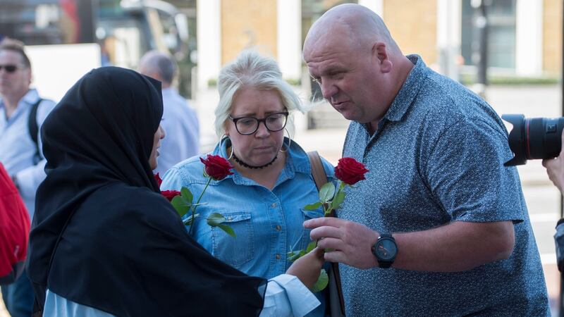 More roses are given out to passers-by on London Bridge.