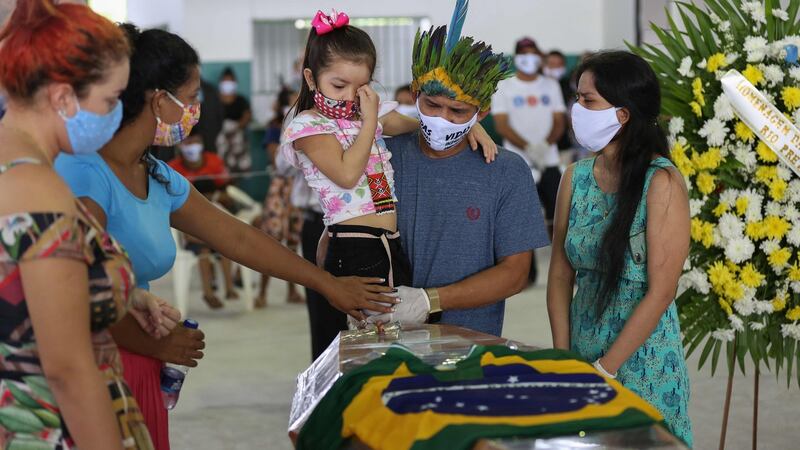 Indigenous from the Parque das Tribos community mourn besides the coffin of Chief Messias (53) of the Kokama tribe who died from coronavirus in Manaus, Brazil. Photograph:  Michael Dantas/AFP