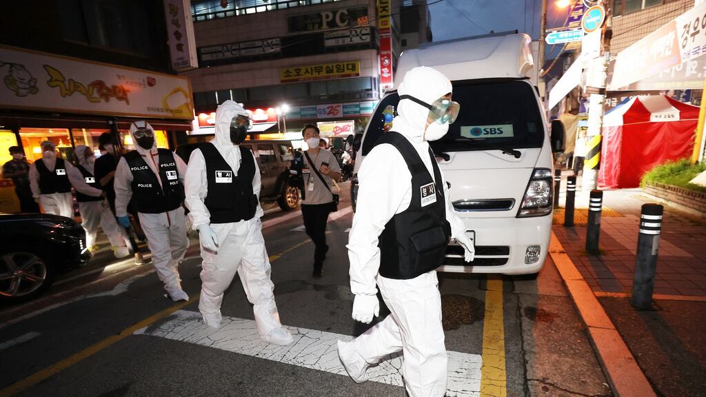 Police officers head towards Sarang Jeil Church for a search and seizure operation. Photograph: EPA