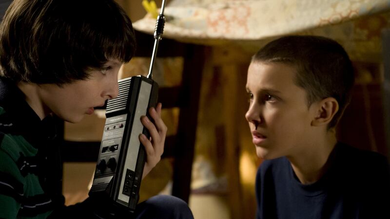 Retro-communication: Mike (Finn Wolfhard) forms a plan with Eleven (Millie Bobby Brown) in the hit first season of ‘Stranger Things’, a Netflix Original  that returns to the platform this week.