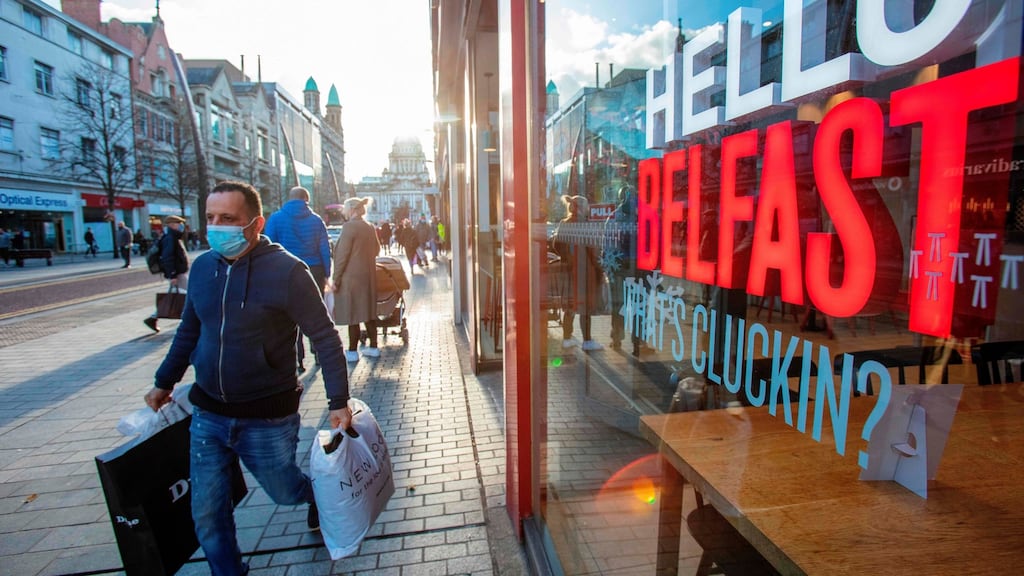 A shopper wears a protective  face covering in Belfast city centre on Christmas Eve, on the day a post-Brexit deal was struck between and UK and EU. Photograph: Paul Faith/AFP/Getty