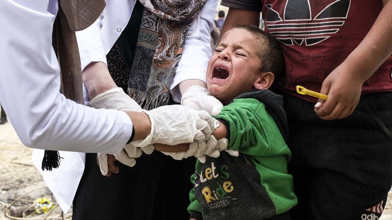 Syrian children, who fled the Turkish incursion, receive medicine for polio and measles in Dohuk, Iraq. Photograph: Byron Smith/Getty Images