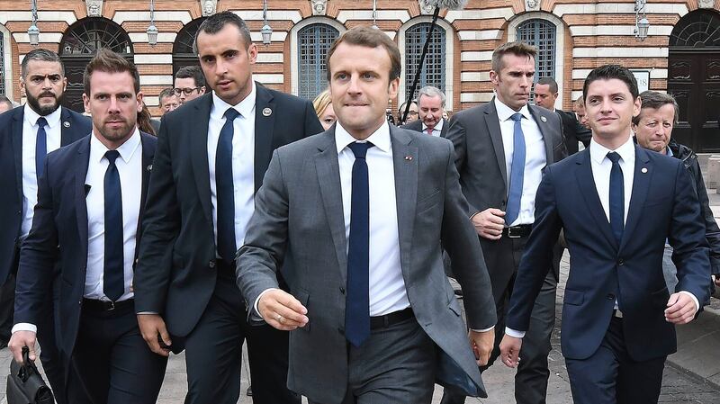 French president Emmanuel Macron, surrounded by members of the presidential security service, at the Place du Capitole in Toulouse,  France. Photograph: Pascal Pavani/AFP/Getty Images