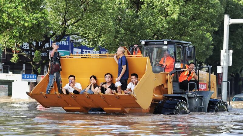 Rescue workers evacuate stranded residents with a bulldozer on a flooded street after typhoon Lekima hit Taizhou, Zhejiang province, China August 11th, 2019. Photograph: Reuters
