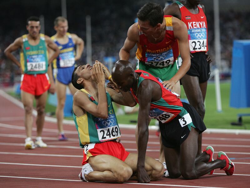 Hicham El Guerrouj of Morocco celebrates with Bernard Lagat of Kenya and Rui Silva of Portugal after he won gold in the men's 1,500 metre final during the Athens 2004 Summer Olympic Games.  Photograph: Michael Steele/Getty Images