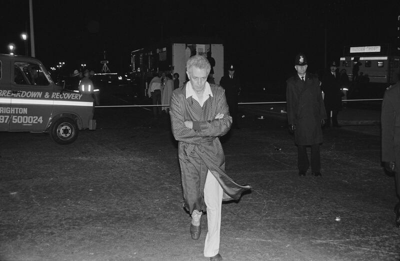 Education minister Keith Joseph, still in his dressing gown, is evacuated from the Grand Hotel. Photograph: Larry Ellis/Daily Express/Hulton Archive/Getty Images