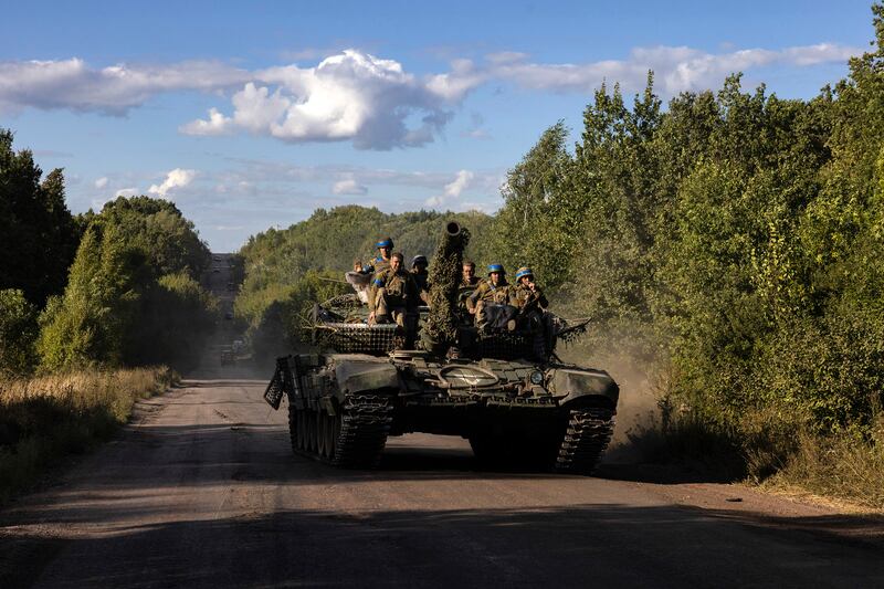 Ukrainian troops with a tank near the Russian border, in the Sumy region of Ukraine, on August 12th, 2024. Photograph: David Guttenfelder/The New York Times                 