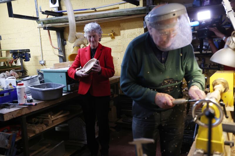 Presidential candidate Catherine Connolly with Mick Kelleher in the Clane Men's Shed while canvassing in County Kildare. Photo: Bryan O’Brien / The Irish Times