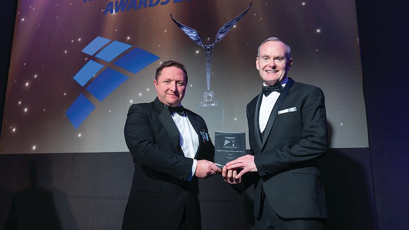 Wayne Tyrrell, awards judge, presents the excellence in people and workplace culture award to Sean Murphy, Aer Lingus