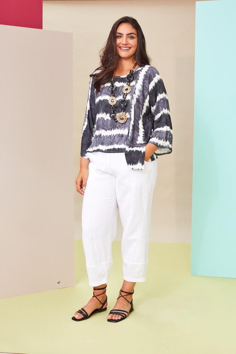 White tapered trousers €118 worn with print top with uneven hem €129