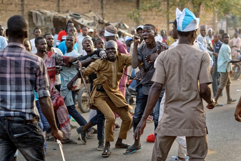 Supporters of the ruling party and main opposition party briefly pull knives and machetes on each other during an otherwise celebratory gathering of supporters of president Muhammadu Buhari anticipating victory, in Kano, northern Nigeria on  Monday. Photograph: Ben Curtis/AP
