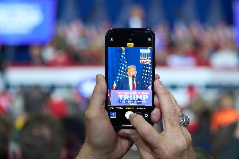An attendee takes a picture of former US President Donald Trump during a campaign event in Green Bay, Wisconsin on Tuesday. Photograph: Daniel Steinle/Bloomberg    