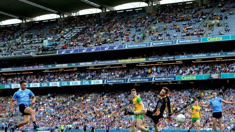 Niall Scully scores his second goal of the game past Donegal’s Shaun Patton. Photo: James Crombie/Inpho