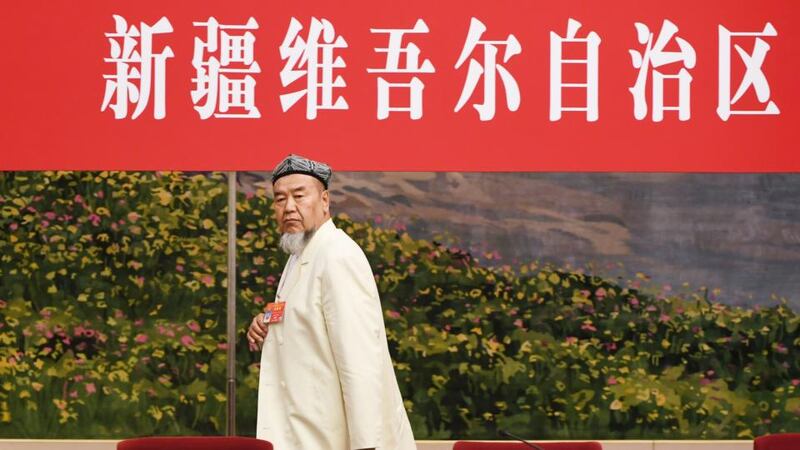 A Uighur delegate leaves the room at the end of the Xinjiang delegation meeting at the ongoing National People’s Congress at the Great Hall of the People in Beijing on March 12th. Photograph: Greg Baker/AFP/Getty