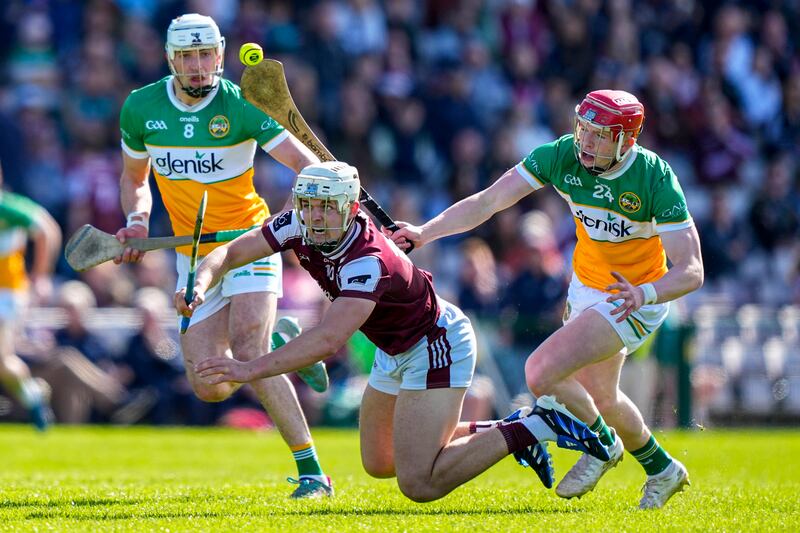 Rory Burke of Galway is tackled by Ruairí Kelly of Offaly. Photograph: James Lawlor/Inpho