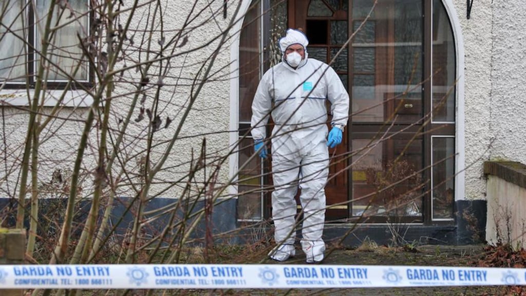 Gardaí pictured at the scene where the body of a man in his 40s was found in a house on Glendhu Road in Cabra on Sunday. Photograph: Collins Dublin