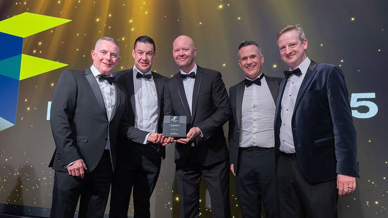 John McDonagh, managing director at Solutions, presents the fit out contractor of the year award to Structure Tone team