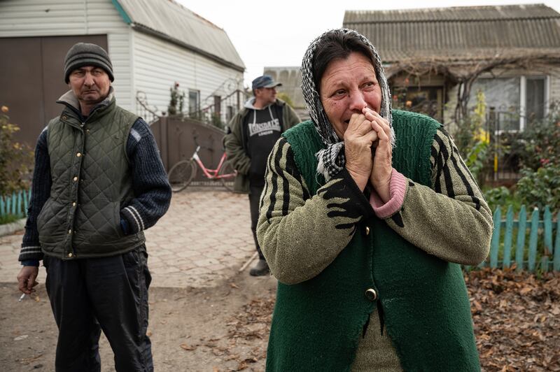 Antonina Ustymenko, 64, weeps as she talks about life under Russian occupation in Blahodatne, Ukraine, a village about 15 miles northwest of central Kherson, on Friday, Nov. 11, 2022. "We are glad we are free now,” she said. “When we saw our guys, we started to hug them. We saw that people in Kyiv live a normal life. Here we live in hell." (Lynsey Addario/The New York Times) — NO SALES —