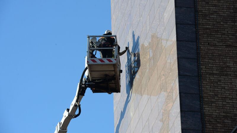 The statue  being removed from the  Treasury Building in Dublin’s Grand Canal Street Lower. Photograph: Alan Betson