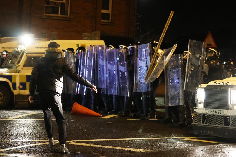 Objects thrown towards PSNI officers with riot shields on Springfield Road in Belfast during unrest in April 2021. A call has been made for tougher sentences for those who attack emergency workers as the number of assaults rise. Photograph: Liam McBurney/PA