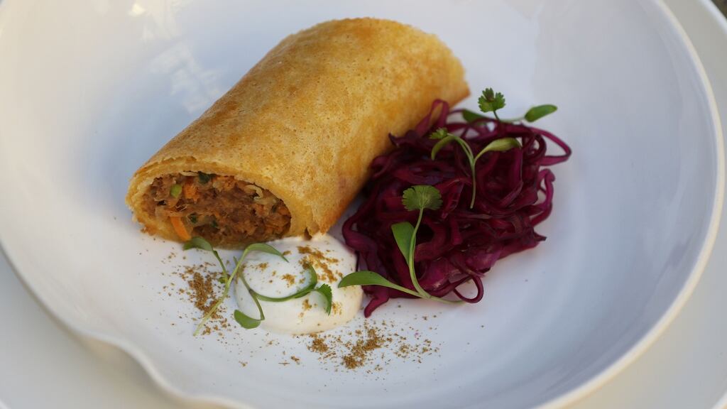 Slice the spring roll diagonally across before serving with pickled cabbage and a drizzle of cumin yogurt. Photograph: Nick Bradshaw