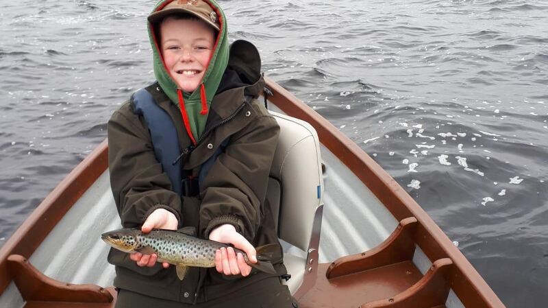 Kyle O’Mahoney (10) with one of his two trout while fishing with his dad on Lough Mask