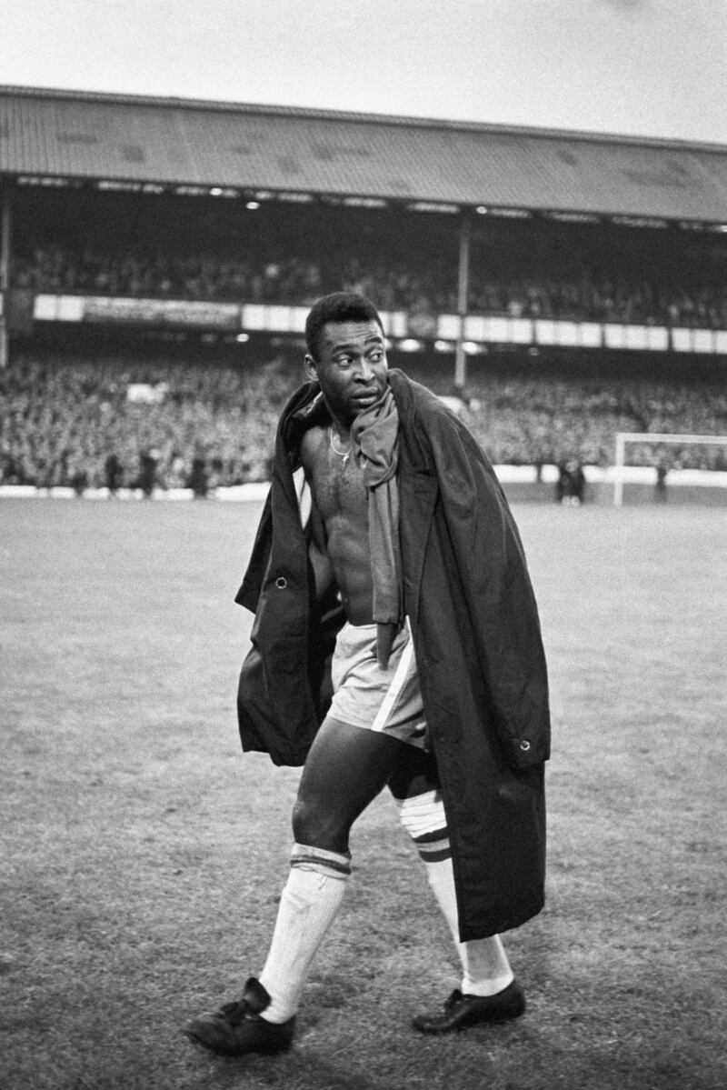 An injured Pele of Brazil trudges off as his side lose to Portugal 3-1 during the 1966 World Cup.