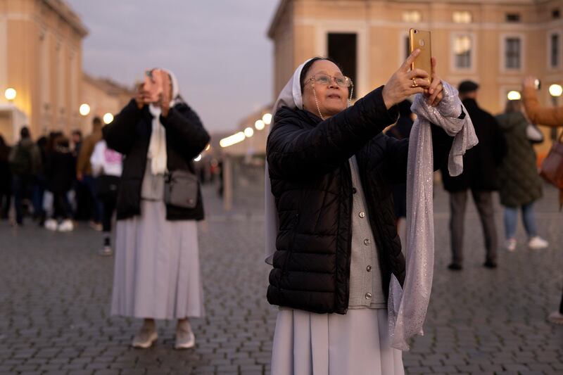 Nuns take photographs in St Peter's Square after paying their respects to the late Emeritus Pope Benedict XVI. Photograph: Christopher Furlong/Getty Images