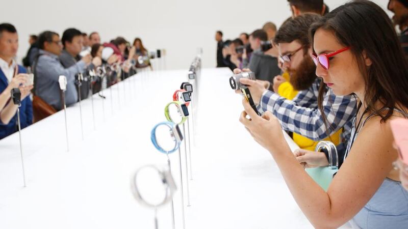 Members of the media photograph and examine the Apple Watch during Apple’s launch event at the Flint Center in Cupertino, California. Photograph: EPA