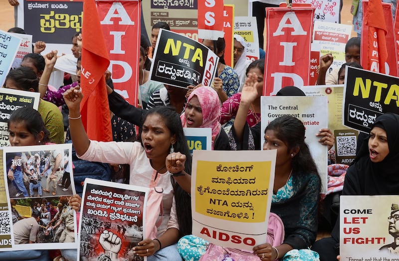 Demonstrators hold placards during a protest against Delhi police over clashes with Cockroach Janta Party supporters. Photograph: EPA