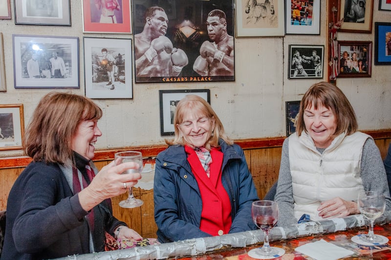 Debbie Derkoski, Karen Anderson, and Pat Smith chat at Jimmy’s Corner on December 10th. Photograph: Natalie Keyssar/The New York Times