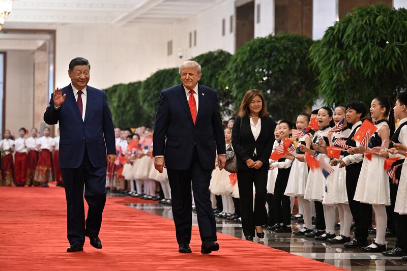 If Trump was impressed by the military display, he showed most enthusiasm for a group of children who leapt up and down holding flowers and Chinese and American flags. Photograph: Kenny Holston/The New York Times