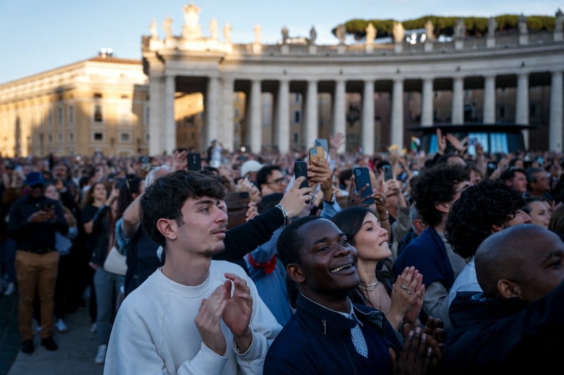 People react as newly elected Pope Leo XIV addresses the crowd from the main central loggia balcony of St Peter's Basilica for the first time. Photo: Getty Images