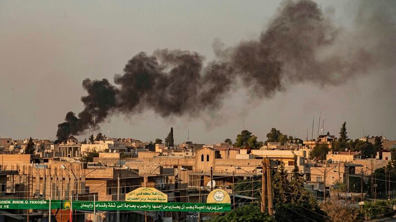 Smoke billows in the background following Turkish bombardment in the northeastern town of Ras al-Ayn in Syria’s Hasakeh province along the Turkish border. Photograph: Delil Souleiman/AFP/Getty Images