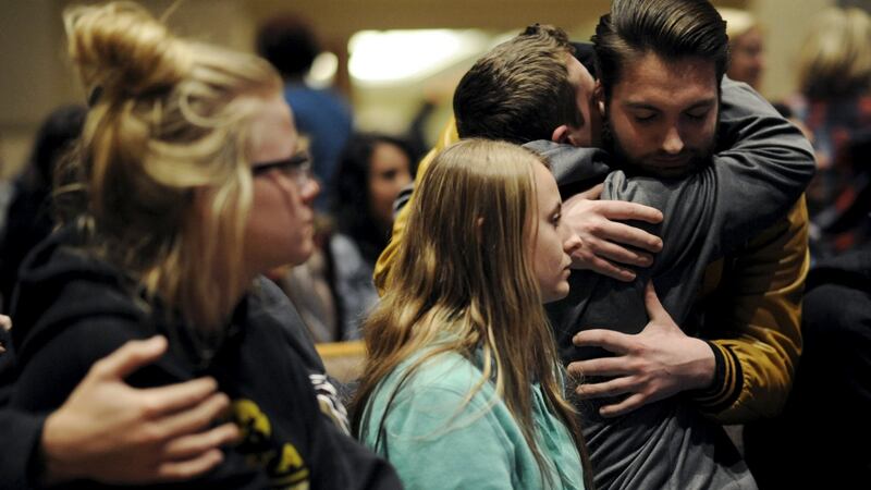 People hug at a vigil after six people were shot dead in  Kalamazoo County, Michigan, on Sunday. Photograph: Reuters