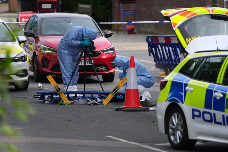Forensic police officers photograph the scene where two people were stabbed on Wednesday in the Golders Green area of London, England. Photograph: Carl Court/Getty Images