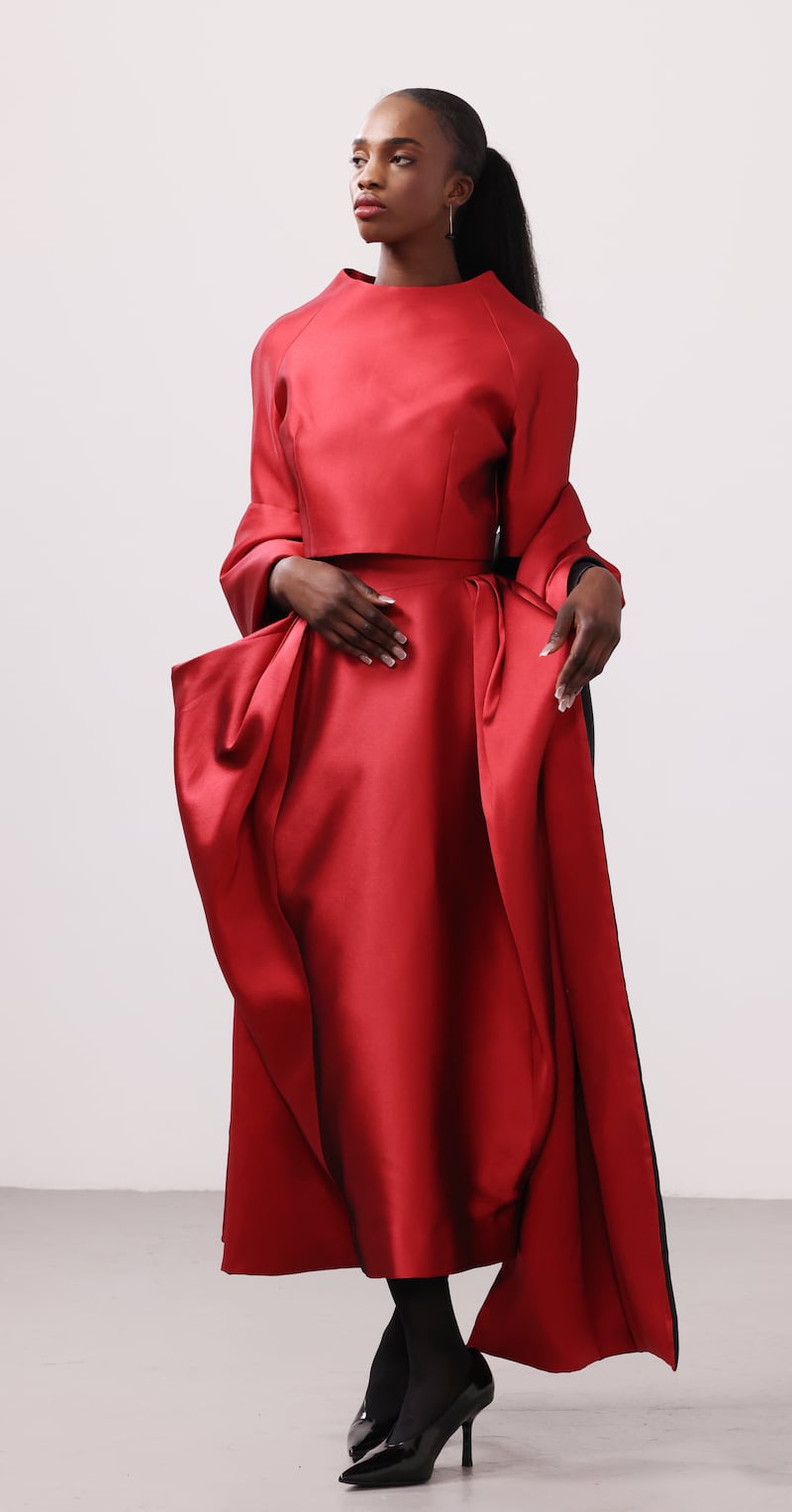 Smokey red mikado cropped top with handmade black cord buttons, €595, draped skirt with back slit, €695, and red and black satin interlined reversible wrap, €450, all from AndTate