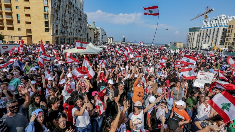 Protesters wave Lebanese flags and shout anti-government slogans  in front of the government palace in Beirut last year. EPA/Nabil Mounzer
