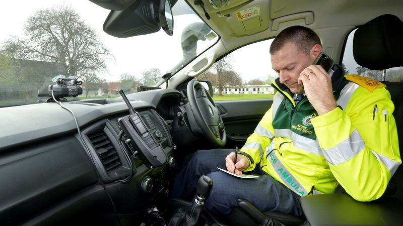 Chief ambulance officer for north Leinster Richard Quinlan takes a patient’s details from his car. Once the tester arrives at the address, he or she parks roughly about 1km away from the house so they have time to prepare the paperwork and ring the patient. Photograph: Alan Betson