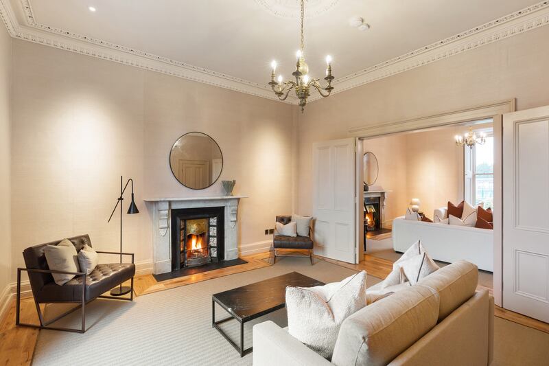 Both rooms that retain original open fireplaces – all chimneys have been serviced and cleaned – have new carpets bordered with oak, Photograph: Angela Mujica