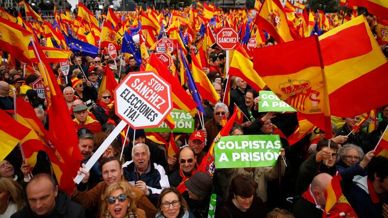 Demonstrators hold banners and Spanish flags during a protest in Madrid, Spain, on Sunday. Photograph: AP Photo/Andrea Comas