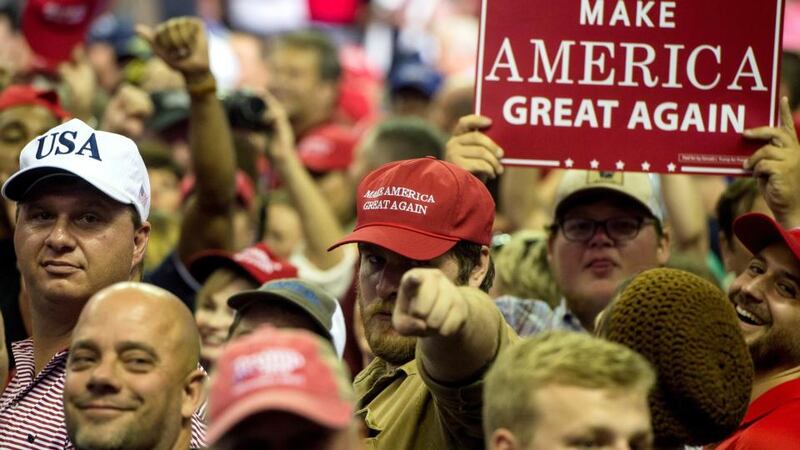 Supporters of Donald Trump turn to face the press platform after Trump criticiSed what he called members of the ‘fake news’ media. Photograph: Brandon Dill/EPA