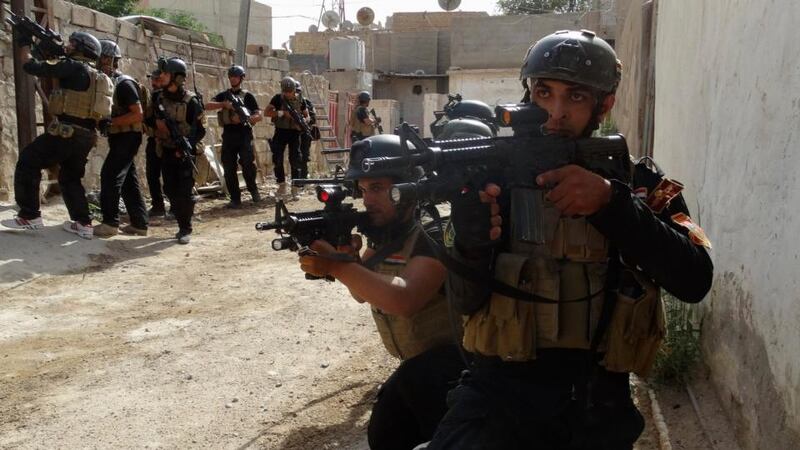 Members of the Iraqi Special Operations Forces  take their positions during a patrol looking for militants of the Islamic State of Iraq and the Levant (Isis), explosives and weapons in a neighbourhood in Ramadi. Photograph: Osama Al-dulaimi/Reuters
