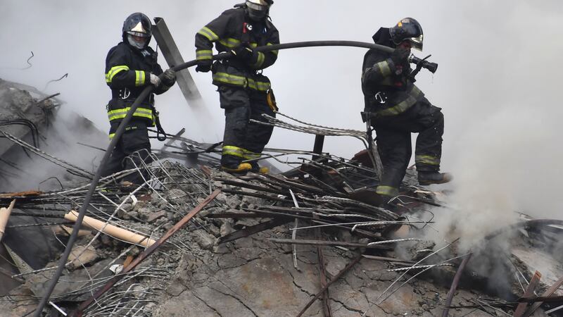 Firefighters work to extinguish the fire in a building that collapsed after catching fire in Sao Paulo, Brazil.  Photograph: Nelson Almeida/AFP/Getty Images